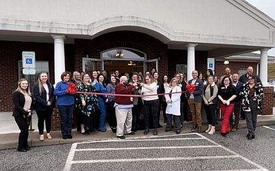 Clinic staff gather for ribbon cutting